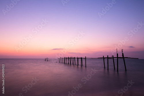 Amazing sunset beach. Long exposure bride wood and colorful suns