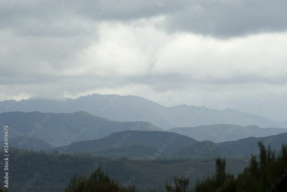 a landscape of clouded mountain ridges stretching off into the distance