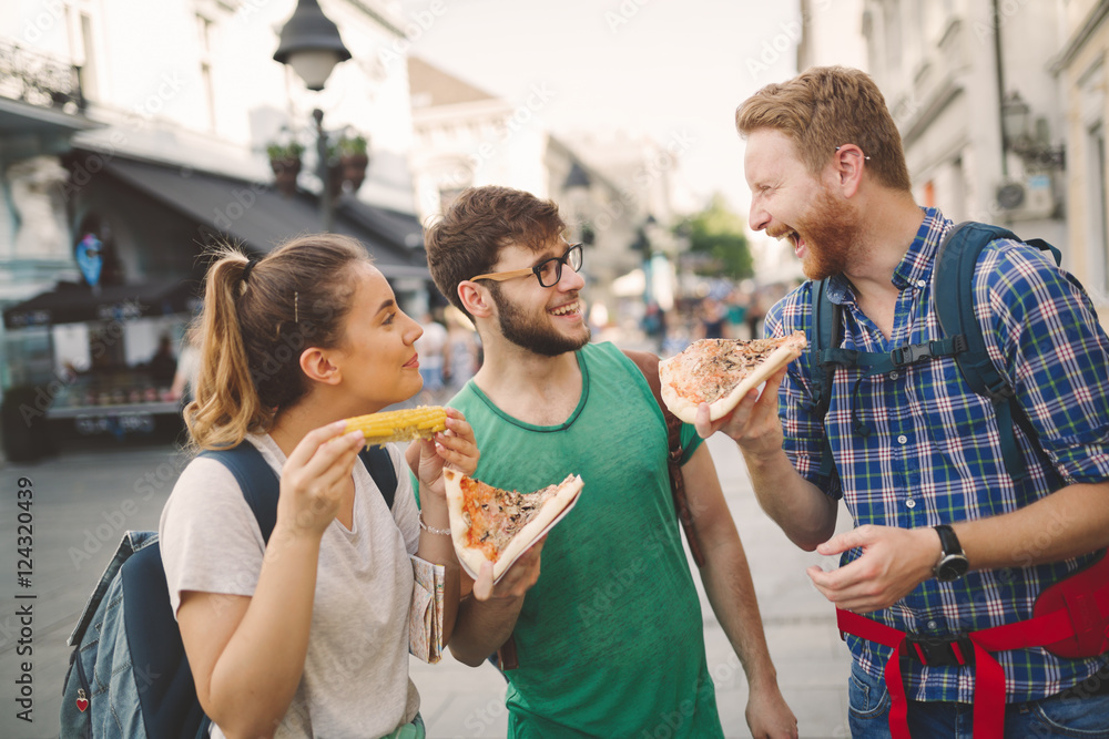 Tourists enjoying pizzas on street