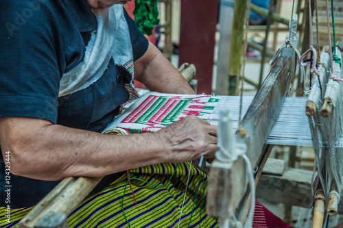 People are weaving; Thailand fabric machine traditional; Asian art manufacturing.