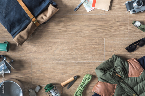 Top View of Autumn/Winter Travel Stuff with Copy Space on Wood Background