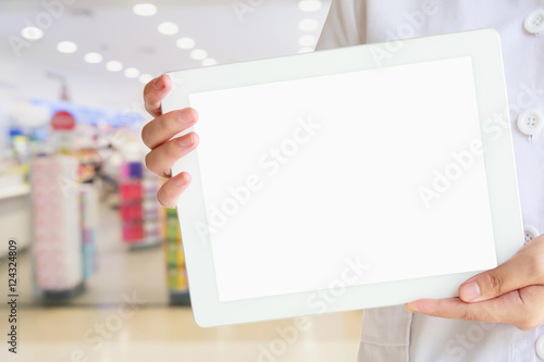Pharmacist showing tablet computer with the pharmacy store