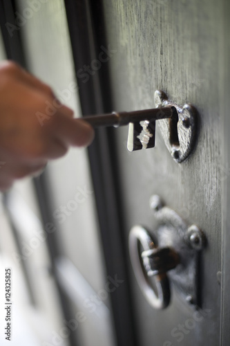 Man inserting a key in a door lock