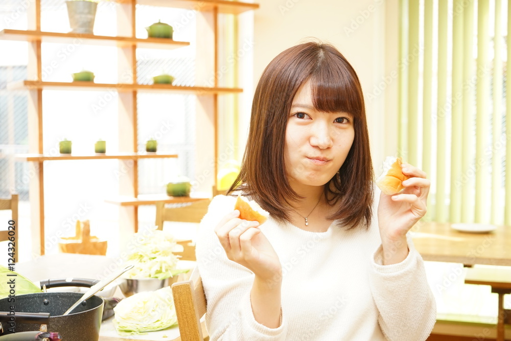 Young Asian woman having a breakfast in her room Young Asian woman having a breakfast in her room