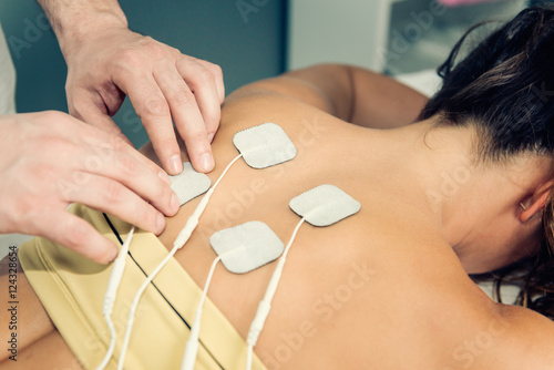 Therapist positioning TENS electrodes photo