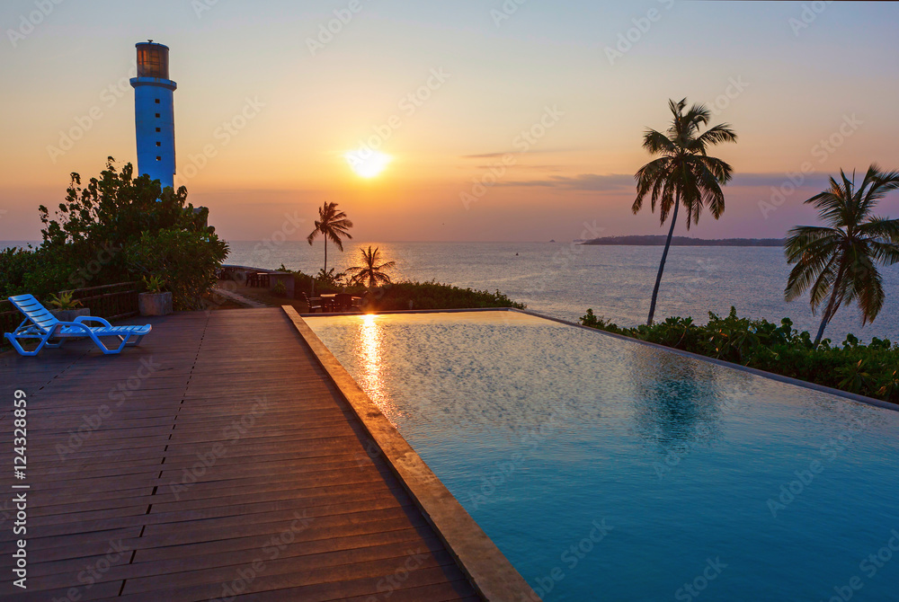 Romantic sunset at pool and sea