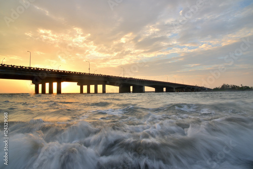 Fototapeta Naklejka Na Ścianę i Meble -  sunset bridge over a sea