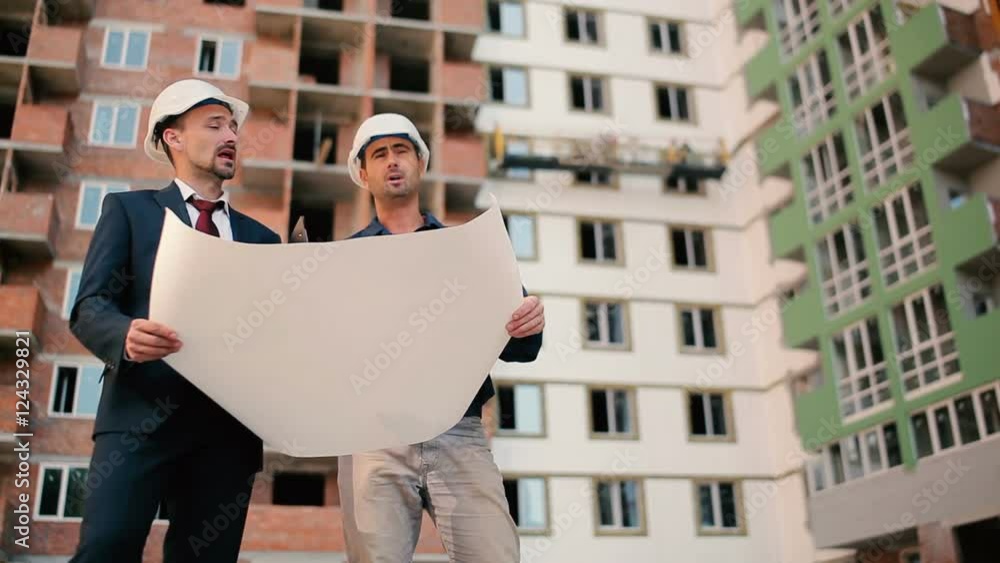 Foremans looking at the building plan Foremans looking at the building plan