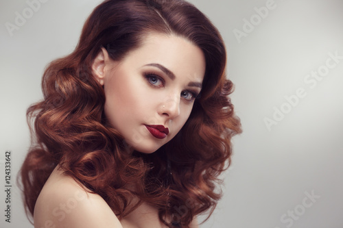 Fashion beauty portrait of a beautiful girl with curly hair luxuriant