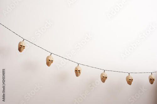 Electric lamp skulls hanging near wall