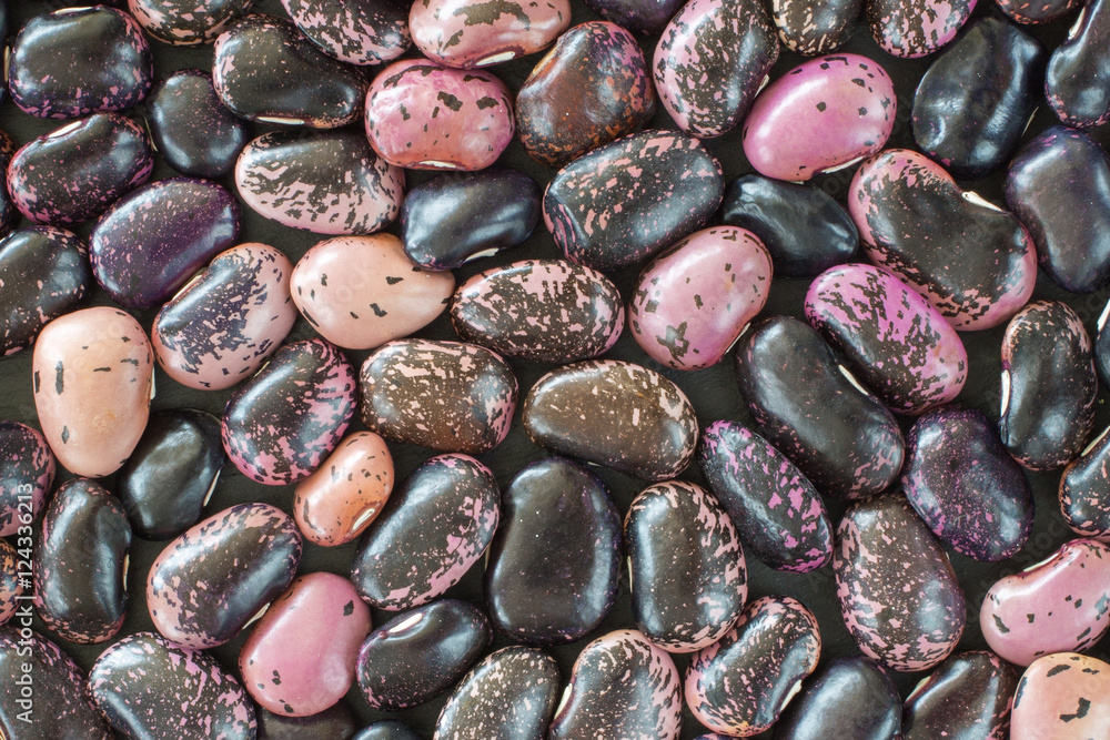 purple bean seeds of different colors on a black background. vegetarian raw food. food color background. bio food purple bean seeds of different colors on a black background. vegetarian raw food. food color background. bio food