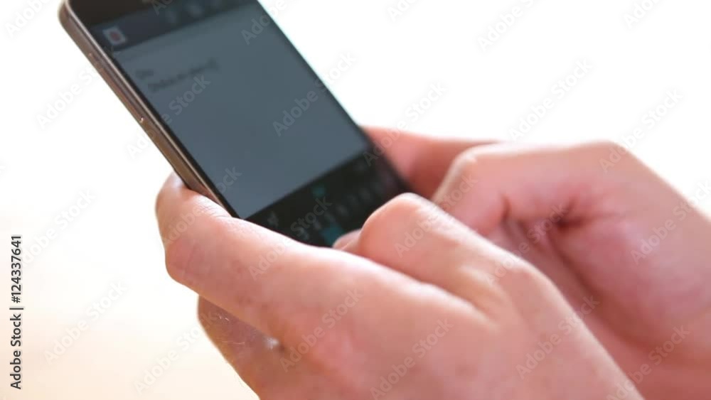 male hands typing and writing on no brand mobile phone smart phone close up male hands typing and writing on no brand mobile phone smart phone close up