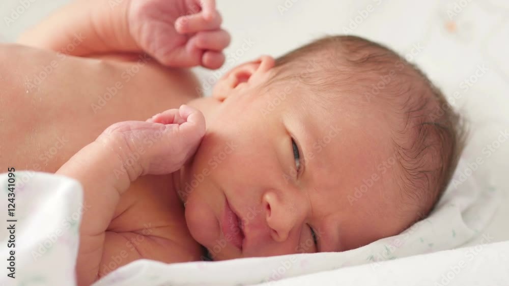 Close up of newborn baby laying on blanket
Close up of newborn baby laying on blanket