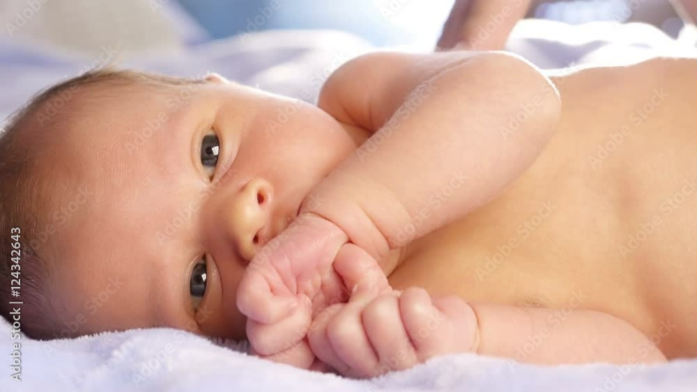 Mom stroking and kissing newborn baby.
Mom stroking and kissing newborn baby.