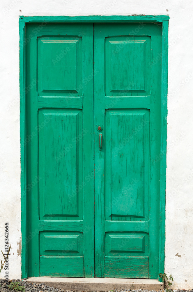 Green wooden door in Betancuria village on Fuerteventura, Canary Islands, Spain