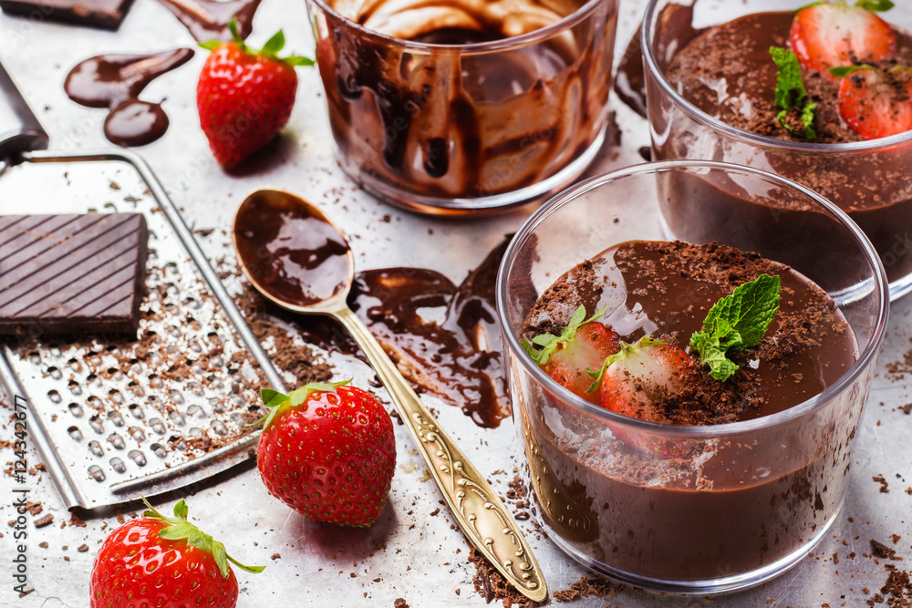 Chocolate mousse with strawberries in glass on rustic table Chocolate mousse with strawberries in glass on rustic table