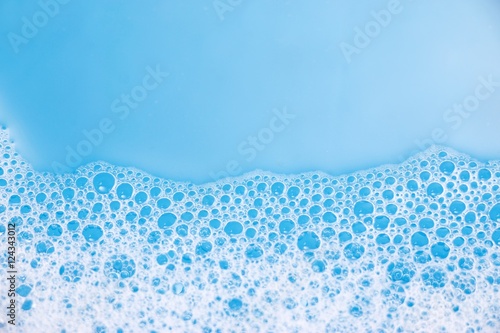 Abstract background of soap foam, suds, shower. Blue background. soft focus, macro view photo