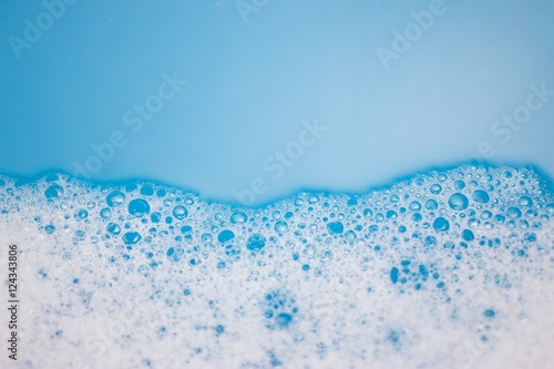 Abstract background of soap foam, suds, shower. Blue background. soft focus, macro view