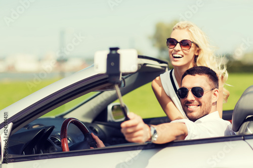 happy couple in car taking selfie with smartphone © Syda Productions