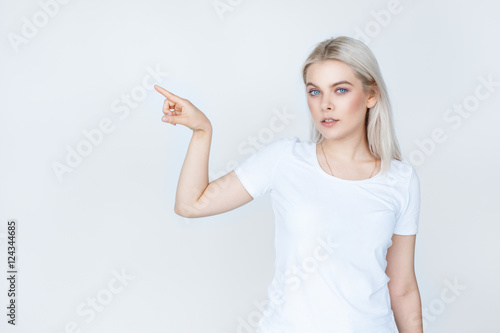 teenage girl in white t-shirt pointing finger away