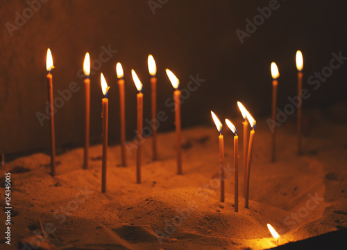 Vibrant religious horizontal background, church candle's flame.