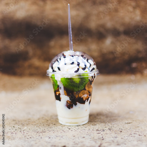 Square food background, whipped cream kiwi dessert in plastic cu