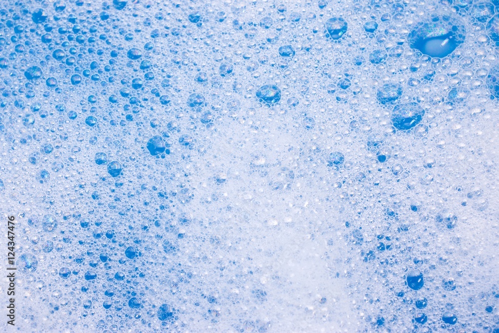 Abstract background of soap foam, suds, shower. Blue background. soft focus, macro view Abstract background of soap foam, suds, shower. Blue background. soft focus, macro view
