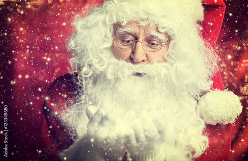 Image of Santa Claus in red costume against dark background