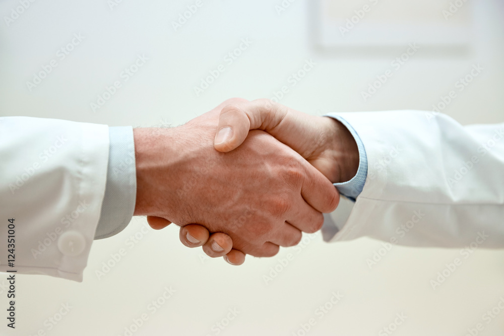 close up of doctors hands making handshake close up of doctors hands making handshake