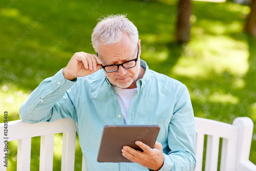 senior man with tablet pc at summer park senior man with tablet pc at summer park