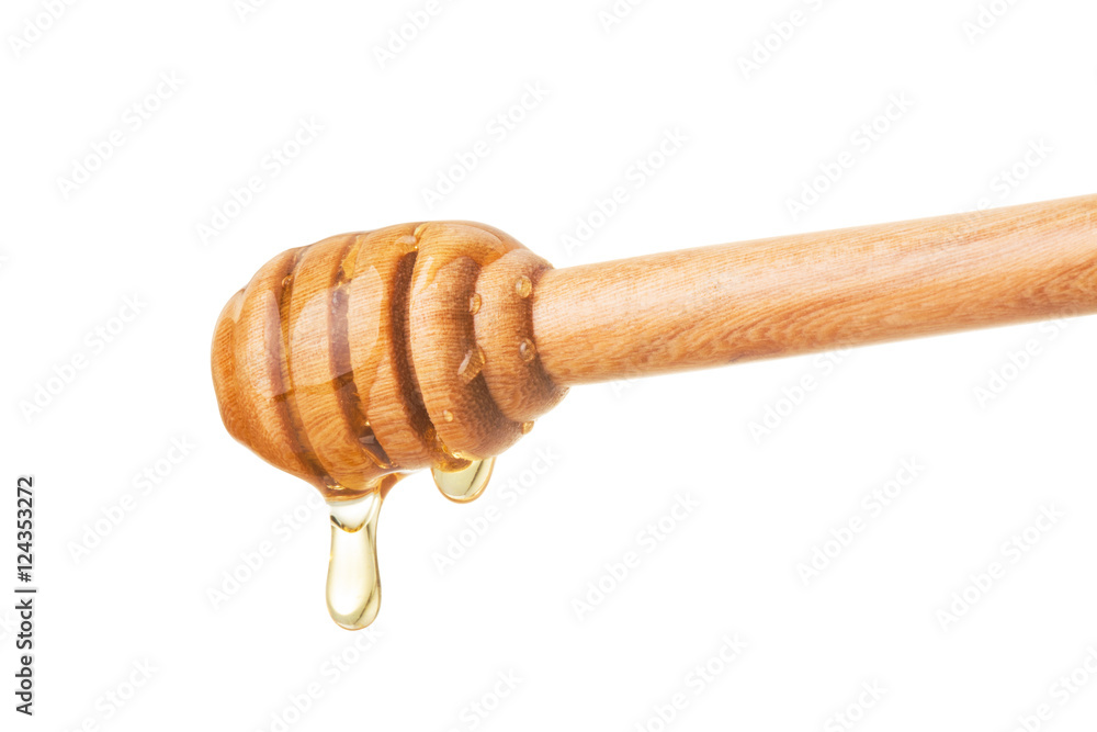 Honey dripping from a wooden dipper on isolate white background. ready to use with clipping path. Honey dripping from a wooden dipper on isolate white background. ready to use with clipping path.