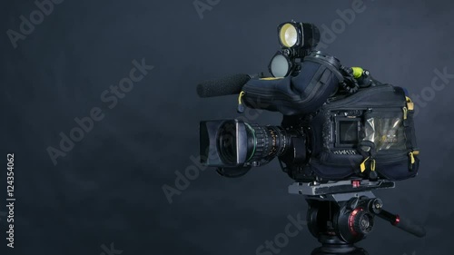 Studio broadcasting camera isolated on black background. 4K. photo