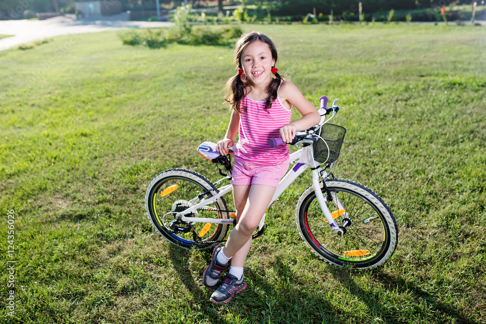 Portrait of funny girl in pink clothes on her bike Portrait of funny girl in pink clothes on her bike