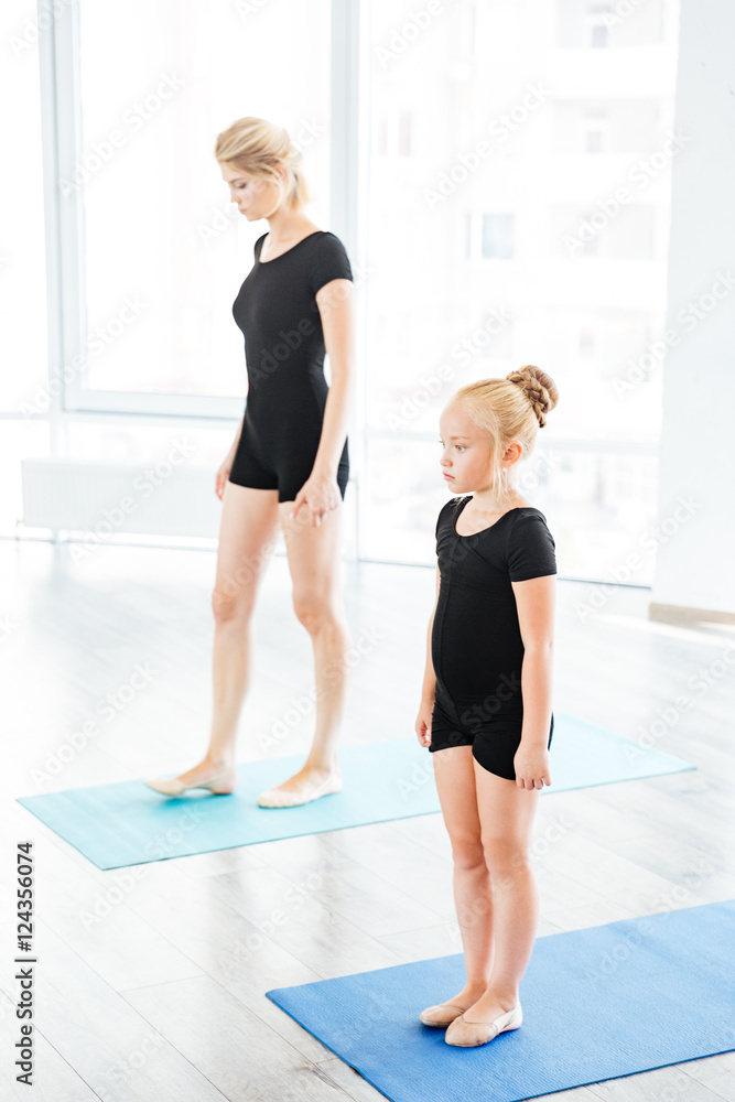Mother teaching daughter ballet at the studio Mother teaching daughter ballet at the studio