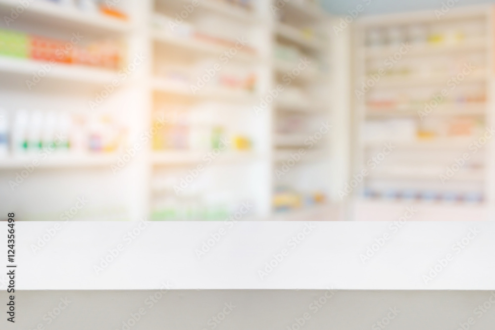 wood counter with blur shelves of drug in the pharmacy