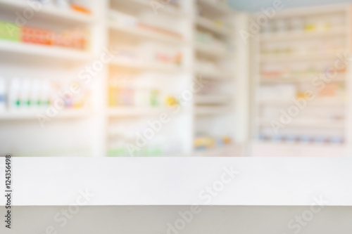 wood counter with blur shelves of drug in the pharmacy