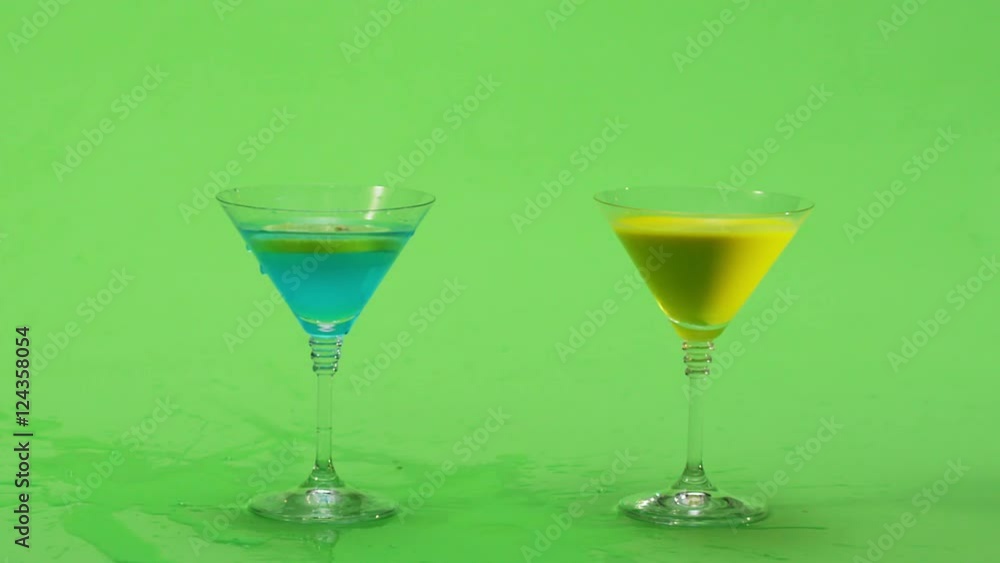 A fresh lemon and strawberry on a cocktail stick is dropped in slow motion into a glass. Green screen. Slow Motion. A fresh lemon and strawberry on a cocktail stick is dropped in slow motion into a glass. Green screen. Slow Motion.