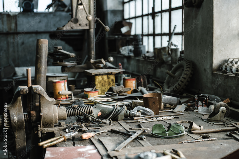 Workbench facing natural light in an old industrial workshop 