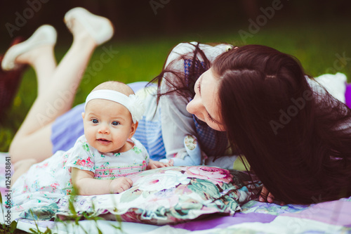 Mother and daughter lying in a meadow photo