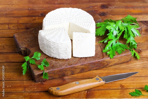 Soft salty cheese on a wooden table