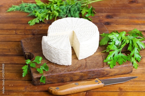Soft salty cheese on a wooden table