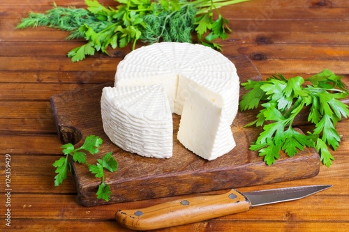 Soft salty cheese on a wooden table