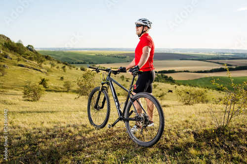 Low angle view of man riding bicycle against sky
