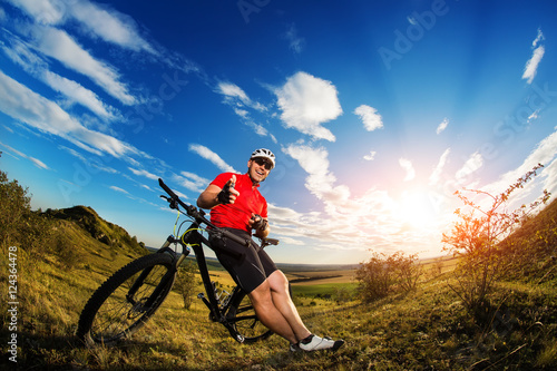 Low angle view of man riding bicycle against sky