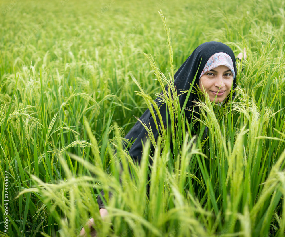 Beautiful happy Muslim woman in green field Beautiful happy Muslim woman in green field