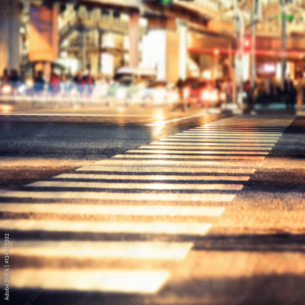 Night view of modern city crossroad  with moving transport. Bangkok, Thailand. Abstract cityscape blurred background, tilt shift, art toning
