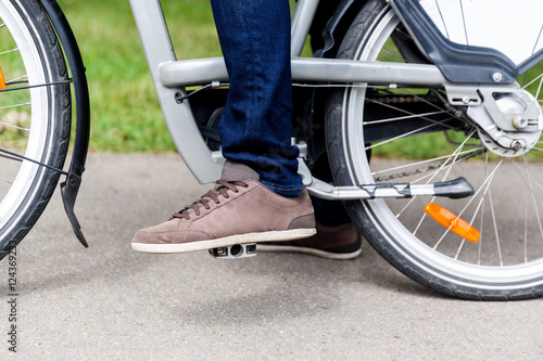 Man on bicycle, leg and fragment of the wheel