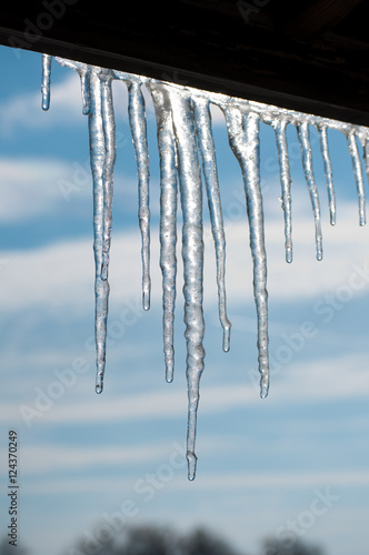 Gorgeous melting icicles against partly cloudy skies