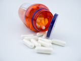 Vitamin supplement pill capsules on white background