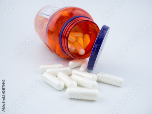 Vitamin supplement pill capsules on white background